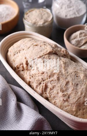 Fresh sourdough in proofing basket on table Stock Photo