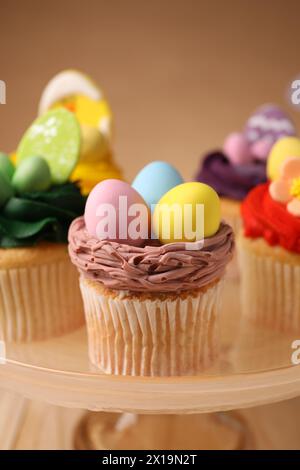 Tasty cupcakes with Easter decor on stand, closeup Stock Photo