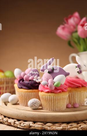 Tasty cupcakes with Easter decor on table Stock Photo