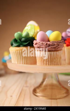 Tasty cupcakes with Easter decor on wooden table Stock Photo