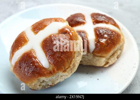 Tasty hot cross buns on gray table, closeup Stock Photo