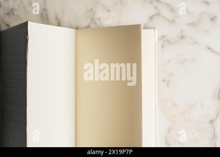 blank pages in handmade book on white marble table Stock Photo