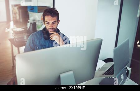 Idea, computer and business man reading email, thinking or problem solving in creative startup office. Pc, serious programmer and planning solution Stock Photo