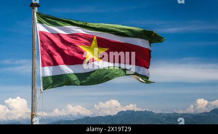 Die Fahne von Suriname, flattert im Wind, isoliert, gegen den blauen Himmel Stock Photo