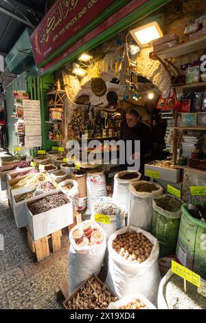 Jerusalem, Israel - February 24 2023: Shop keeper waits for customer for its dry goods such as spices in the Muslim Quarter in Jerusalem wall city old Stock Photo