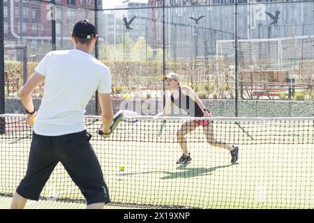 Portrait of two smiling sportsman's posing on padel court outdoor with rackets - Padel players  Stock Photo