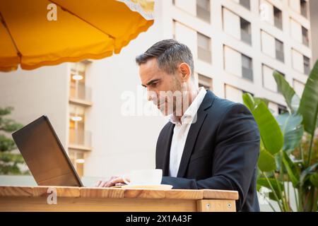 Businessman working on his laptop outdoors. Stock Photo