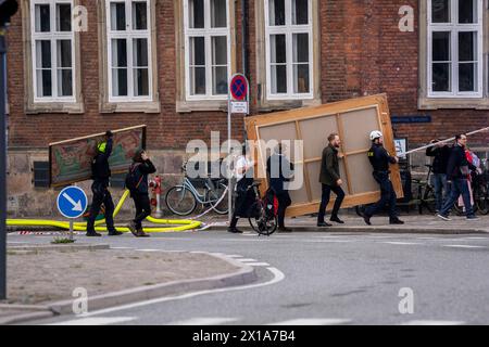 Copenhagen, Denmark. 16th Apr, 2024. People carry historic paintings out of the Boersen during the fire in the historic building Boersen in Copenhagen on Tuesday, April 16, 2024. Credit: Ritzau/Alamy Live News Stock Photo