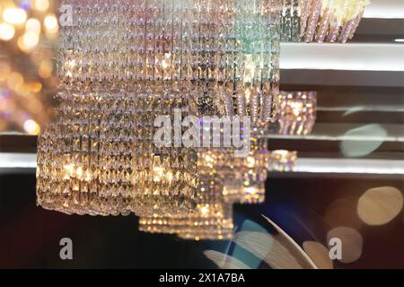 bright crystal  luxury chandelier in the modern ceiling, colorful rays of light Stock Photo