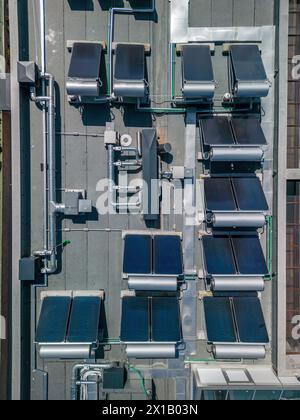 Industry with low carbon footprint. Industrial warehouses with solar panels on the roof. Technology park and factories from above. Stock Photo