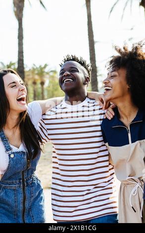 Young multiracial friends having fun during summer vacation outdoors. Stock Photo
