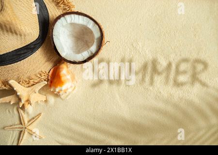 Straw hat, coconut, starfish and shells on white fine sand. Summer ...