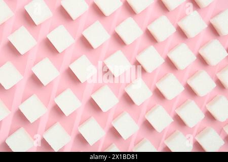 White sugar cubes on pink background, top view Stock Photo