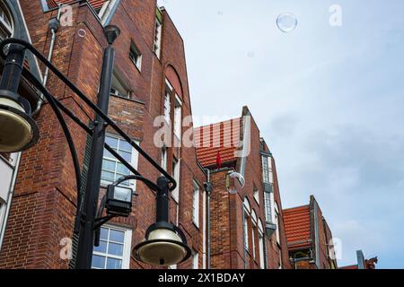 Shimmering soap bubbles rise into the sky in front of Rostock University on University Square, Rostock, Mecklenburg-Western Pomerania, Germany. Stock Photo