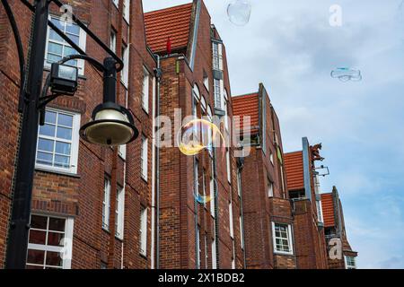 Shimmering soap bubbles rise into the sky in front of Rostock University on University Square, Rostock, Mecklenburg-Western Pomerania, Germany. Stock Photo