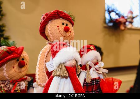 Stuffed hand-made gingerbread men and dolls on sale at a Christmas craft market. Stock Photo