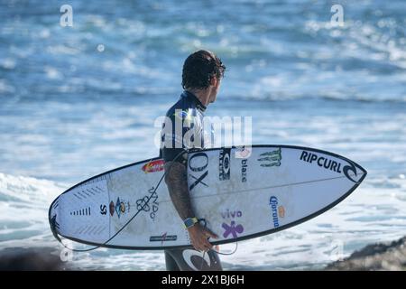 Brazilian professional surfer Gabriel Medina carrying his surfboard after leaving the water at the 2024 Margaret River Pro, Western Australia. Stock Photo