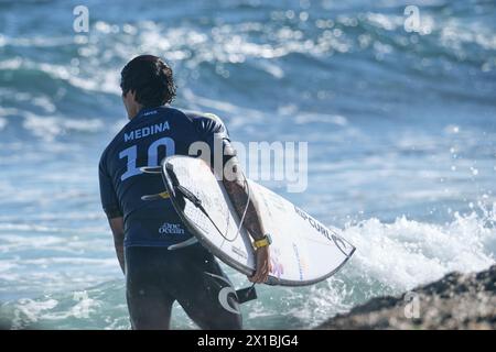 Brazilian professional surfer Gabriel Medina carrying his surfboard after leaving the water at the 2024 Margaret River Pro, Western Australia. Stock Photo