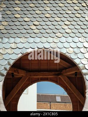 Bermondsey Market place, pavilion clock tower detail with tin-can tiles. The Blue, London, United Kingdom. Architect: Assemble Architects, 2022. Stock Photo