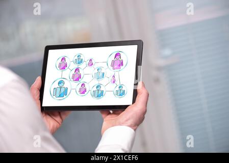 Social network concept shown on a tablet held by a man Stock Photo