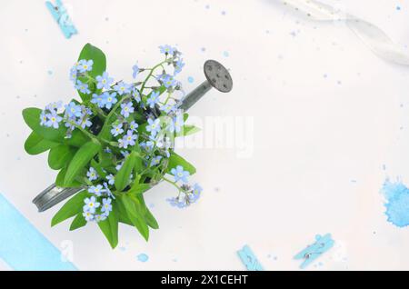Blue flowers (forget-me-nots) with blank space to fill in with content, blue decorations. Top view. Stock Photo