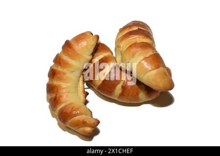 There are oriental sweets on the table. Two bagels with apple filling and one half of a bagel. Stock Photo