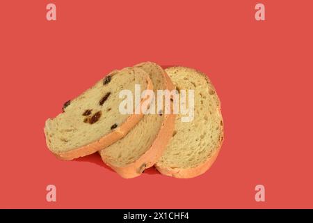 Several crackers with raisins lie on a red background. Stock Photo