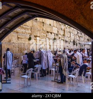 Jerusalem, Israel - April 12, 2024: Scene of Jewish men praying in front of the Western Wall, in the old city of Jerusalem, Israel Stock Photo
