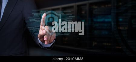 cybersecurity concept. businessman touches hologram of shield with padlock surrounded by binary code Stock Photo
