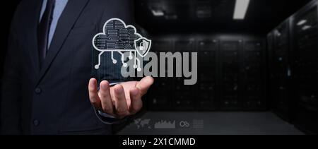 cybersecurity concept. businessman holds cloud hologram with shield and padlock. it rains binary code. Stock Photo