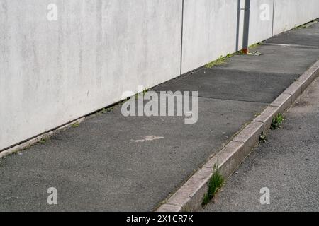 empty sidewalk, in an industrial area, urban elements in perspective without people. Stock Photo