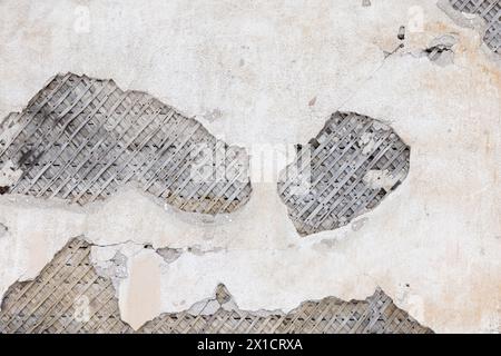 Ancient wooden wall with damaged stucco layer placed over wooden lathing for plaster Stock Photo