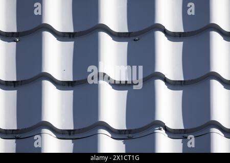 White metal tile roofing pattern with blue shadows, close-up background photo texture Stock Photo