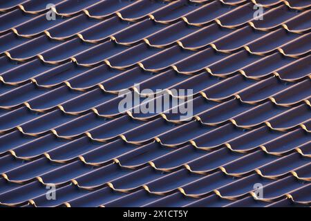 Metal roof tiling with wavy shape pattern, close up photo of modern house roof Stock Photo