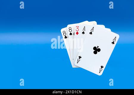 A Pair of Black Aces with Black eights, plus a hole card (in this hand the 3 of Diamonds) Stock Photo