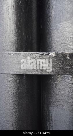 Two black pipes stick together background Stock Photo