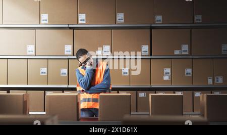 Exhausted female warehouse worker sleeping at work, work burnout concept Stock Photo