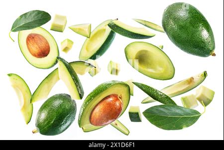 Avocado fruits. leaves and avocado slices levitating in the air isolated on white background. Stock Photo