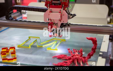 Three dimensional 3d printer printing letter M. Stock Photo