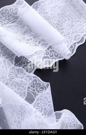 White lace on black background, top view Stock Photo