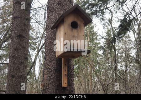 A birdhouse is a closed artificial nesting site for small birds, mainly nesting in hollows. Such nesting sites for small passerine birds are often mad Stock Photo