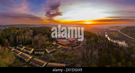 Beautiful sunset landscape view of typical swedish wood houses suburbian middle class residential housing area on top of hill adjacent to nature reser Stock Photo