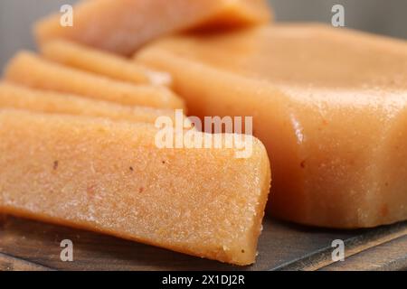 Tasty sweet quince paste on wooden board, closeup Stock Photo