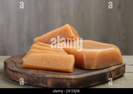 Tasty sweet quince paste on wooden table, closeup Stock Photo