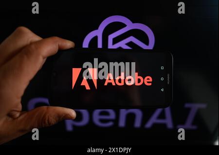 Poland. 16th Apr, 2024. In this photo illustration, an Adobe logo is displayed on a smartphone with an OpenAI logo in the background. (Credit Image: © Omar Marques/SOPA Images via ZUMA Press Wire) EDITORIAL USAGE ONLY! Not for Commercial USAGE! Stock Photo