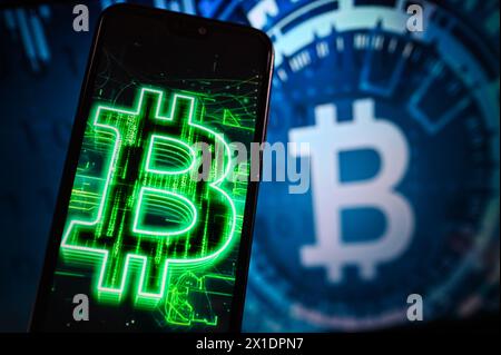 Poland. 16th Apr, 2024. In this photo illustration, a Bitcoin logo is displayed on a smartphone and in the background. (Credit Image: © Omar Marques/SOPA Images via ZUMA Press Wire) EDITORIAL USAGE ONLY! Not for Commercial USAGE! Stock Photo