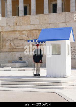 The Evzones, presidential guard, stand guard outside the old Royal Palace that now serves as the Greek Parliament building  in Athens, Greece Stock Photo