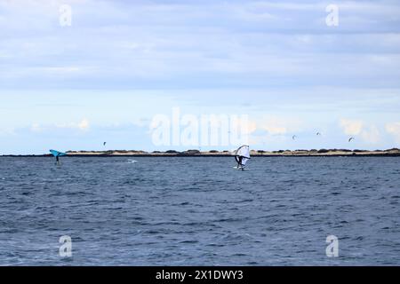 Corralejo, Canary island of Fuerteventura in Spain - November 25 2023: windsurfing in front of the coastline Stock Photo
