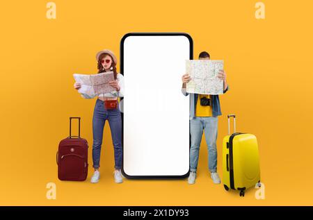 Solo travelers looking at map near phone screen Stock Photo