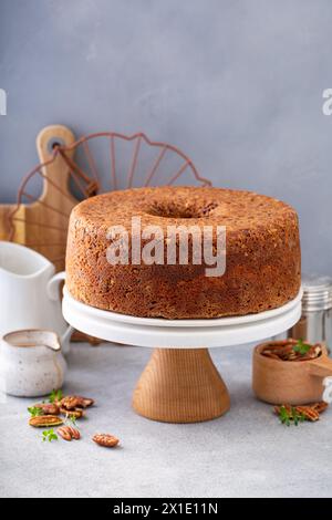 Pecan caramel pound cake baked in a bundt pan, homemade and served on a cake stand Stock Photo